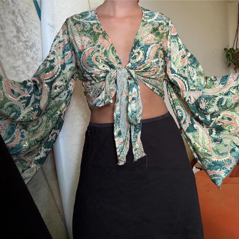 Handmade silk bell sleeve top with metallic detailing.
